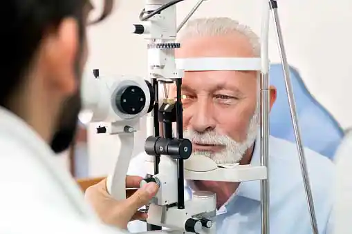 an old man getting his eye checked